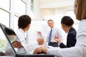 Smiling businessman explaining business ideas to his partners